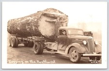 Postcard RPPC Man Spreads Arms at Cut End of Large Log on Truck Oregon c1940s picture