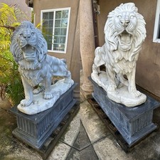 Exquisite Pair of Hand-Carved White Marble Lion Sculptures on Pedestals picture
