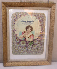 FRAMED ANTIQUE ADVERTISING PIECE FEATURING WOMAN SURROUNDED BY FLORAL MOTIFS picture