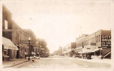 J67/ Bloomer Wisconsin RPPC Postcard c1930 Main Street Stores Oldsmobile 355 picture
