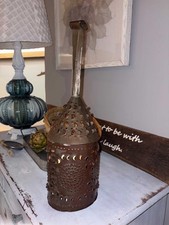 An antique punched metal nutmeg grater with a tapering handle. picture